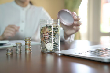 Piggy bank. Woman at the background.