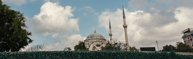 Fototapeta na wymiar Clouds above Mihrimah Sultan Mosque in Istanbul, Turkey, banner