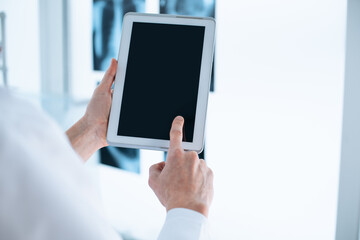 close-up. doctor is tapping on the screen of the digital tablet.