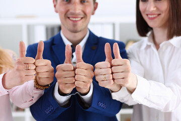 Group of people show OK or approval with thumb up