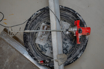 Close up.  Dirty Plasterer equipment batch  in construction side