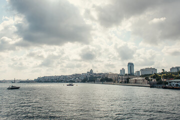 Fototapeta premium Ships in sea near seafront with cloudy sky at background, Istanbul, Turkey