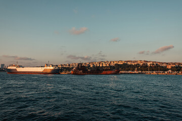 Fototapeta na wymiar Ships near seafront and Istanbul city during sunset, Turkey