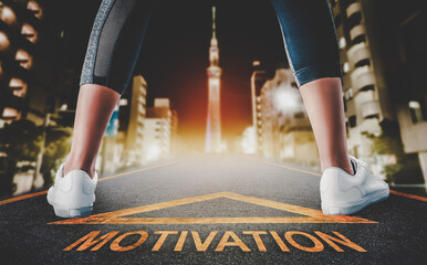 Woman runner leg standing on a motivation road sign leading to a Tokyo night city for motivation...