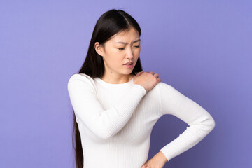 Young asian woman isolated on purple background suffering from pain in shoulder for having made an effort