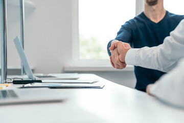 close up. handshake of financial partners near the desktop.