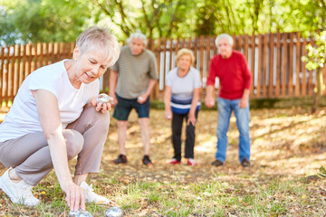 Fototapeta premium Group of seniors as retirees playing boules