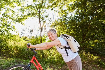 Vital senior woman riding a scooter in nature