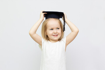 Portrait little girl is wearing graduate hat and smile with happiness with copy space for education concept