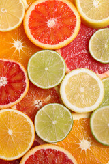 Fresh juicy citrus fruits as background, top view