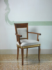 Armchair in wood with seat and back in fabric 