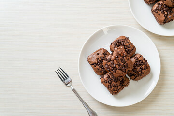 dark chocolate brownies topped by chocolate chips