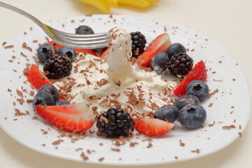 dessert with berries and cream