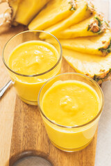 Fresh pineapple smoothies on the table. Morning light healthy breakfast with organic pineapple fruit
