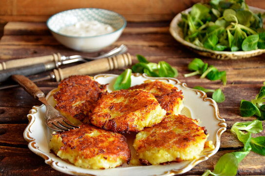 Potato rosti pancakes on a rustic saucer on a wooden background