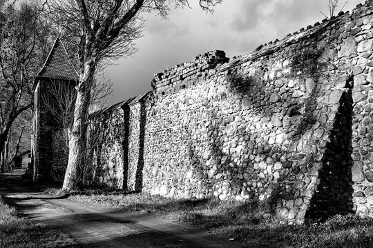 Medieval defensive walls with a tower in the city of Osno