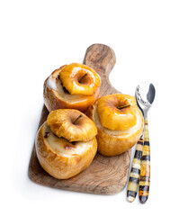 Baked apples stuffed with soft cheese and nuts isolated on white
