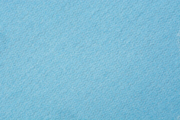 Wavy parallel fine grain textures on a blue background with the inclusion of white and black dots