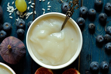 Rice congee gruel in a bowl against a blue background