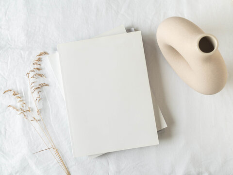 Empty blank white magazine cover mock up, vase and dried grass