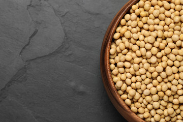 Soy in bowl on black table, top view. Space for text