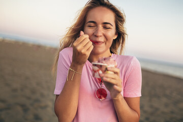 Girl eating ice cream on the beach