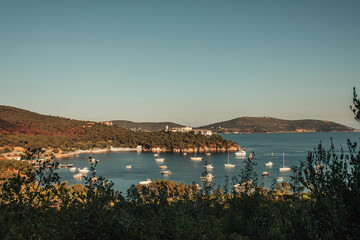 yachts in sea bay, surrounded by green hills