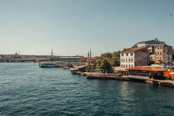 Naklejka premium view from Bosphorus strait of seashore with buildings and moored ships, Istanbul, Turkey