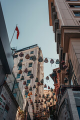 low angle view of traditional wicker lanterns between houses in Balat, Istanbul, Turkey