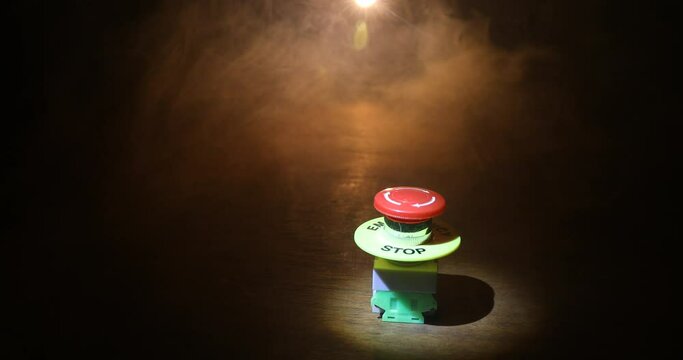 Emergency stop button, Disaster protection. Industrial concept. Red button on table in dark low key background. Selective focus