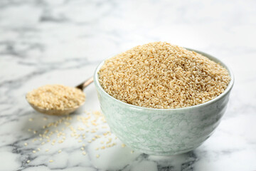 Sesame seeds in bowl on white marble table