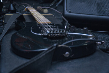 Black electric guitar with tremolo on a hard case