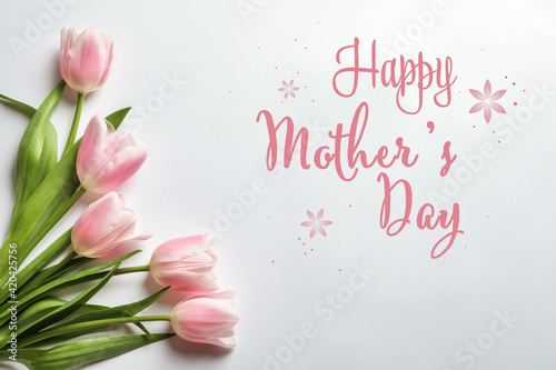 Happy Mother's Day. Beautiful tulips on white background, flat lay