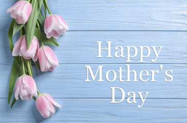 Happy Mother's Day. Beautiful tulips on light blue wooden background, flat lay