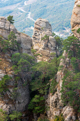 Rocky landscape with pines on top of Yuzhnaya Demerdzhi mountain in Crimea. Dolina Privideniy, or Ghosts Valley is popular tourist destination.
