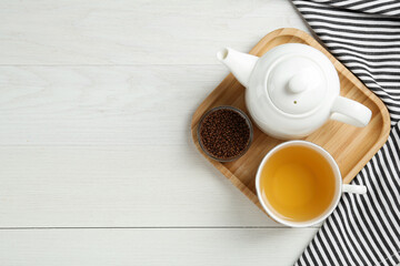 Fototapeta na wymiar Buckwheat tea and granules on white wooden table, flat lay. Space for text