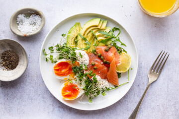 Healthy breakfast with egg, smoked salmon and avocado