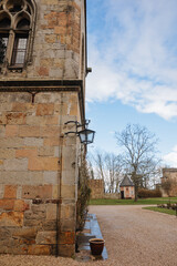 Fototapeta premium Black iron lamp on an old building in Germany. Wall lantern on an old castle 