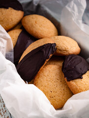 Homemade biscuits with dark chocolate served on a box. Backgroud of delicious biscuits with selective focus and copy space.