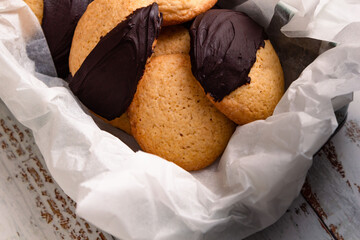 Homemade biscuits with dark chocolate served on a box. Backgroud of delicious biscuits with selective focus and copy space.