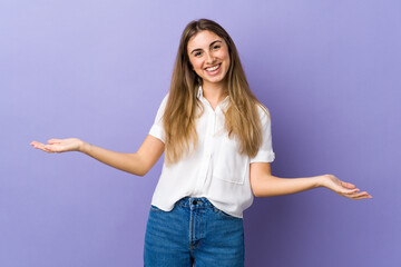 Young woman over isolated purple background having doubts