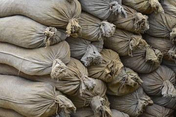 Rough canvas sandbags stacked in a wall