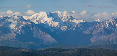 Snow capped mountain peaks on a summer morning
