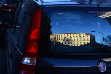 House reflection in the rear window of a car