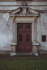 Seminary entrance in Przemysl, Poland. Decoration of the doors of buildings in the old town. Very old entrance with two wooden doors and beautiful detailed ornaments in this antique architecture.