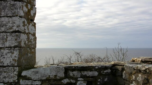 Clouds passing over medieval stone gallows in time lapse
