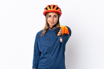 Young hispanic cyclist woman isolated on white background showing thumb down with negative expression