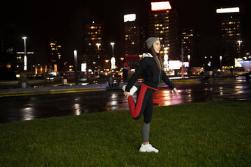 Woman stretching her legs before her outdoor training