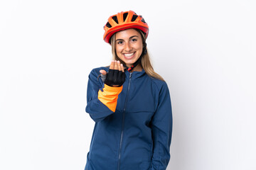 Young hispanic cyclist woman isolated on white background inviting to come with hand. Happy that you came