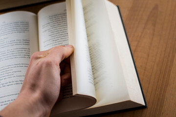 Human hand opening a book